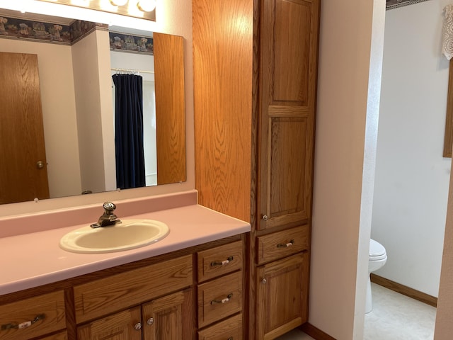 bathroom featuring vanity and toilet