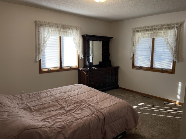 carpeted bedroom featuring a textured ceiling