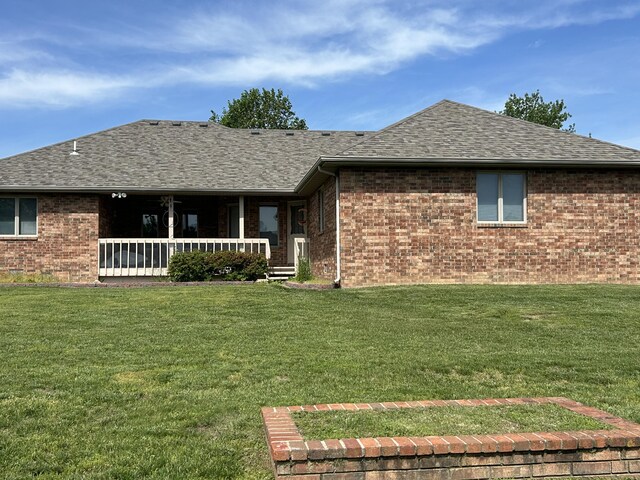 1660 S Meadow Ln, Bolivar, MO 65613 - rear view of house featuring brick siding, a shingled roof, and a lawn