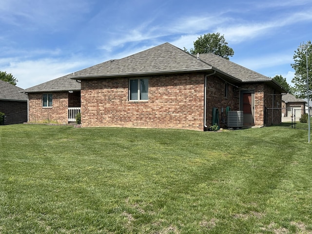 1660 S Meadow Ln, Bolivar, MO 65613 - rear view of house featuring roof with shingles, central AC unit, and brick siding