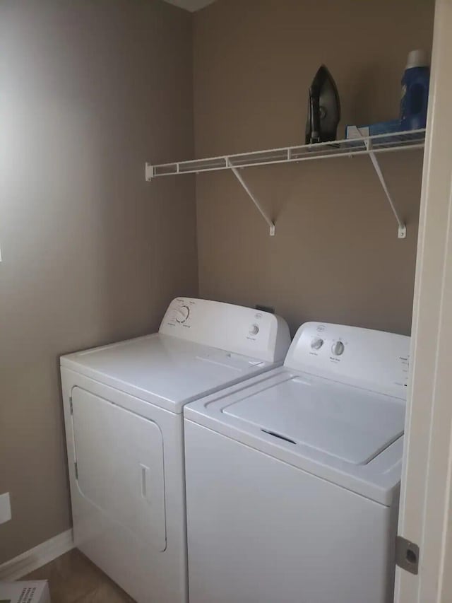 laundry area with tile patterned flooring and washer and dryer