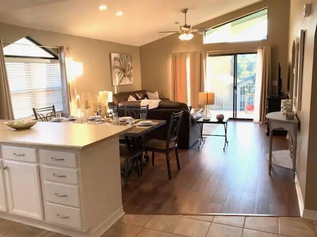 kitchen with white cabinetry, light hardwood / wood-style flooring, a wealth of natural light, and vaulted ceiling