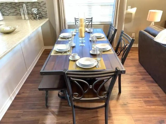 dining area featuring dark wood-type flooring