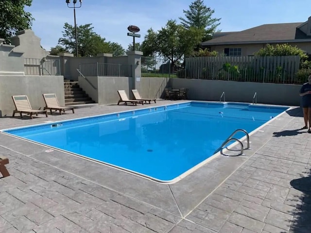 view of swimming pool with a patio area