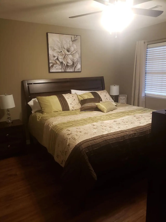 bedroom with ceiling fan and dark hardwood / wood-style flooring