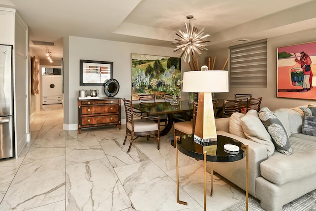 dining area featuring an inviting chandelier