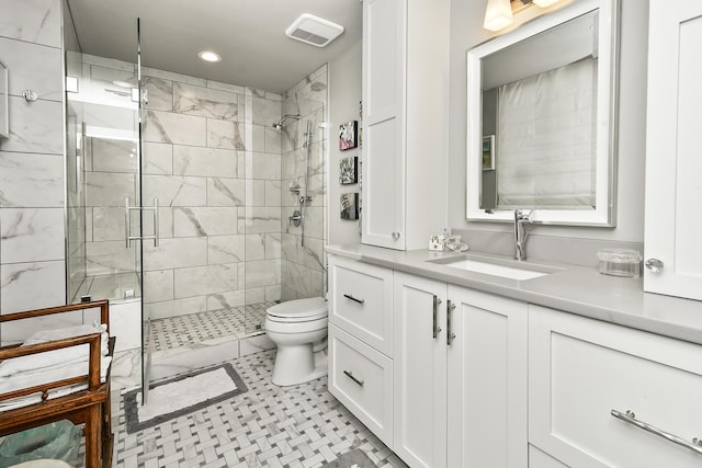 bathroom featuring vanity, toilet, and walk in shower