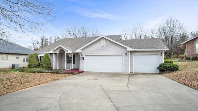 single story home with a garage and central air condition unit