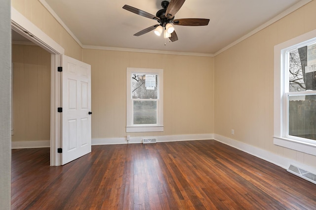 spare room with ceiling fan, crown molding, and dark wood-type flooring