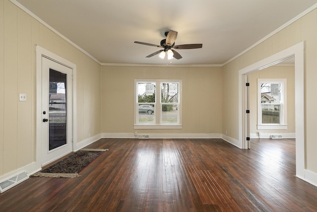 empty room with ceiling fan, ornamental molding, and dark wood-type flooring