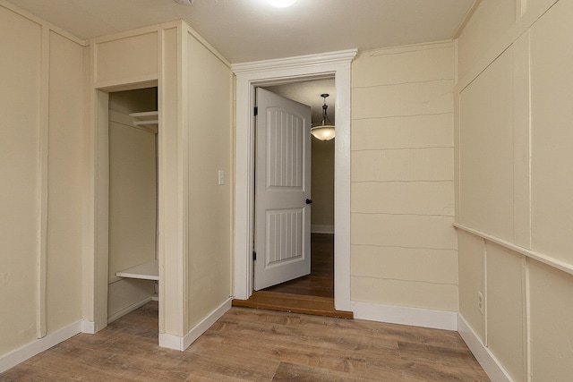 hallway with hardwood / wood-style floors