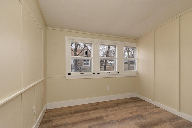 spare room featuring wood-type flooring