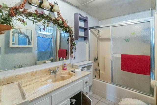 bathroom with tile patterned flooring, vanity, and shower / bath combination with glass door