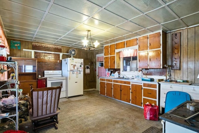 kitchen featuring light carpet, white appliances, hanging light fixtures, and wooden walls