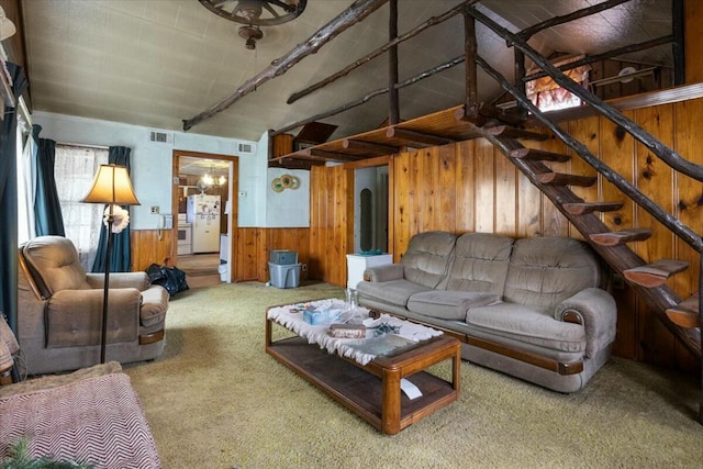 living room featuring wooden walls and carpet