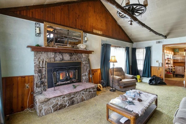 carpeted living room with vaulted ceiling, a stone fireplace, and wood walls