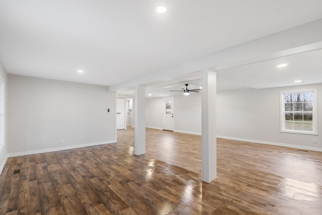 basement with dark hardwood / wood-style floors and ceiling fan