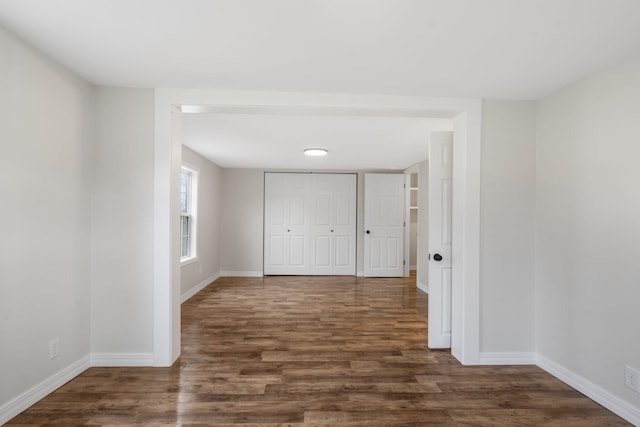 hallway with dark wood-type flooring