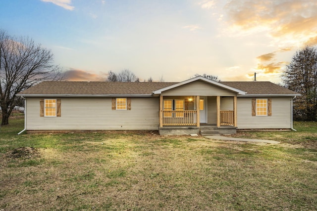 single story home with a lawn and covered porch