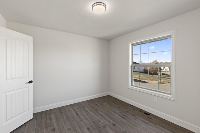 spare room with dark hardwood / wood-style floors