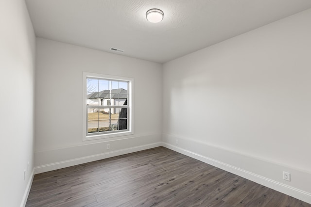 empty room featuring dark hardwood / wood-style floors