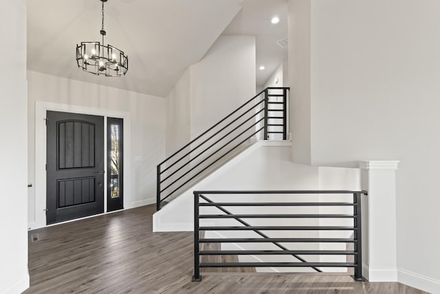 foyer entrance featuring dark hardwood / wood-style flooring and an inviting chandelier