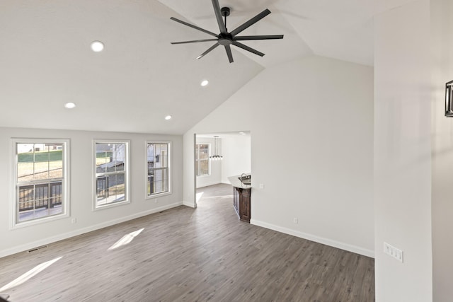 unfurnished living room with hardwood / wood-style flooring, ceiling fan, and lofted ceiling