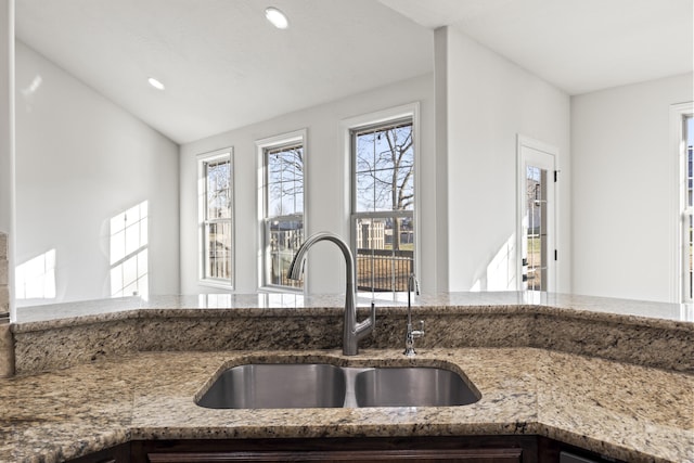 kitchen with stone countertops and sink