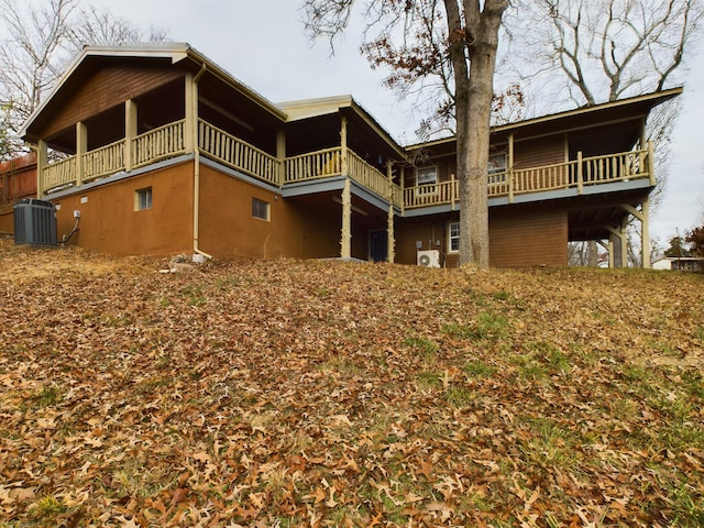 rear view of house with a balcony and central air condition unit