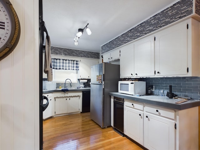 kitchen with stainless steel fridge, sink, black dishwasher, light hardwood / wood-style floors, and white cabinetry