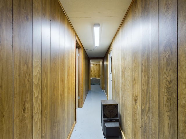 hall featuring wooden walls