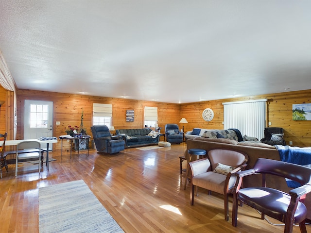 living room featuring wood walls and wood-type flooring