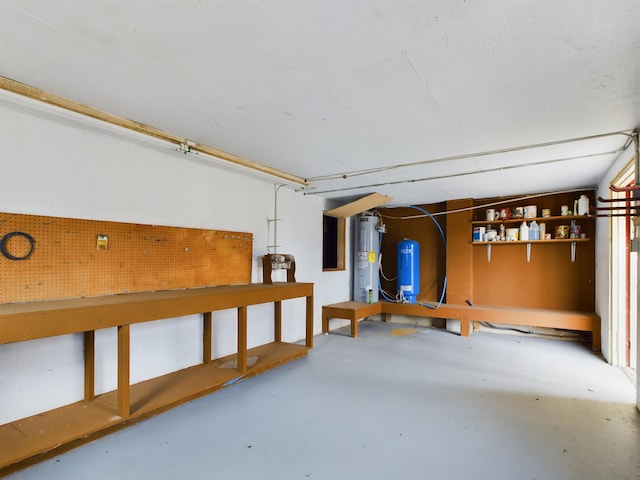 basement featuring a workshop area and water heater