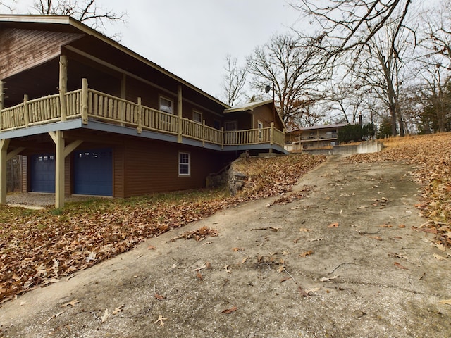 view of property exterior with a garage and a balcony