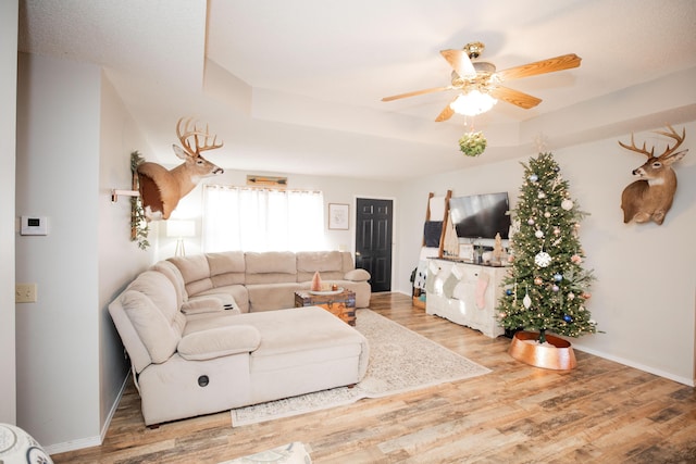 living room featuring hardwood / wood-style flooring and ceiling fan