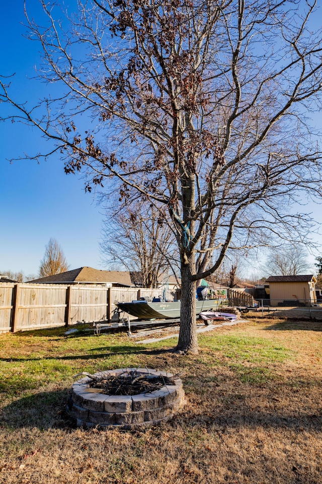 view of yard with a fire pit