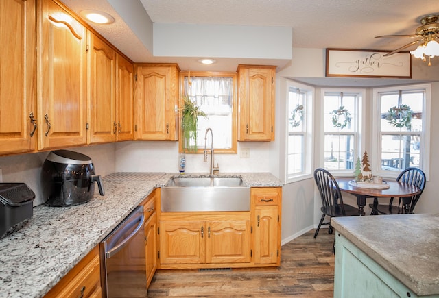 kitchen with dishwasher, dark hardwood / wood-style floors, sink, and a wealth of natural light