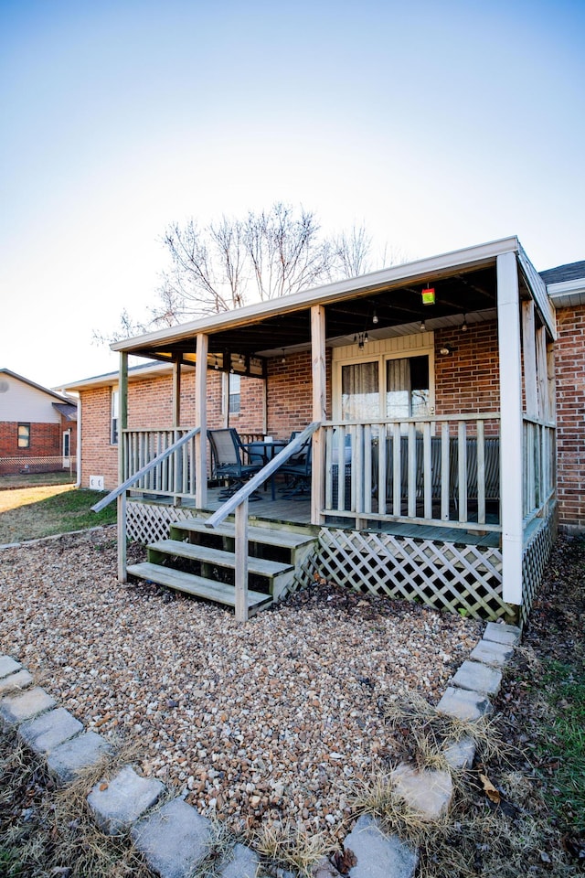 rear view of house with covered porch