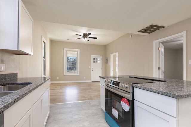 kitchen with light hardwood / wood-style flooring, white cabinetry, stainless steel electric stove, and ceiling fan