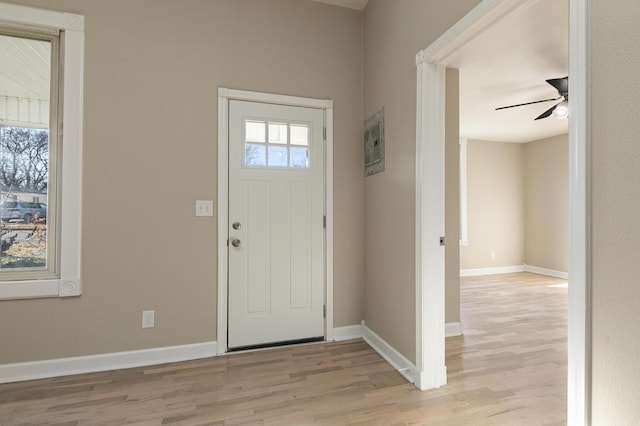 foyer with ceiling fan, light wood-type flooring, and a wealth of natural light