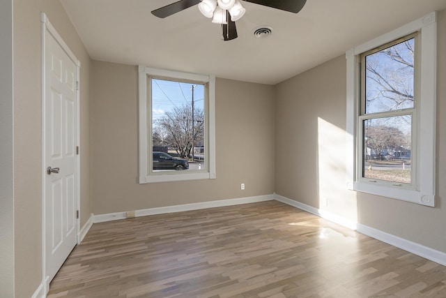 empty room with ceiling fan and light wood-type flooring