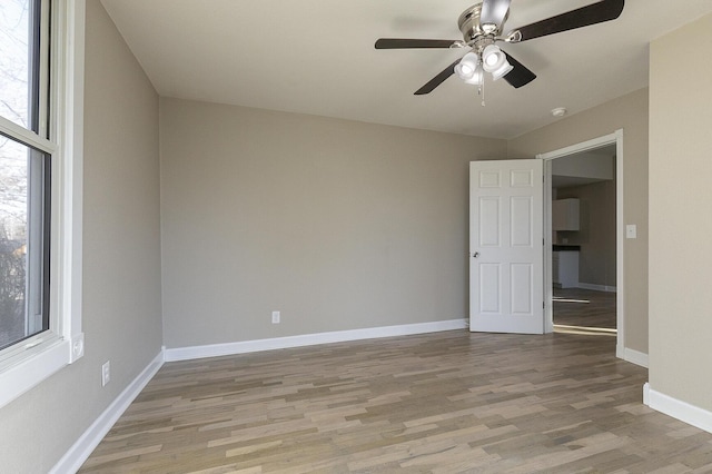 empty room featuring light wood-type flooring and ceiling fan