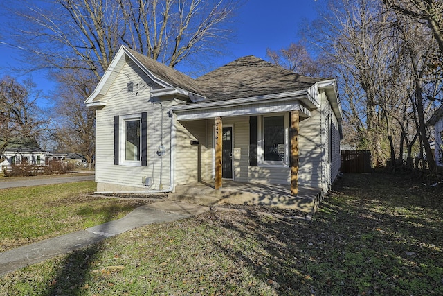 bungalow-style house featuring a porch and a front lawn