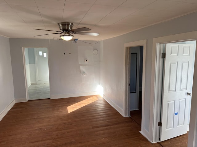 spare room with ceiling fan and dark wood-type flooring