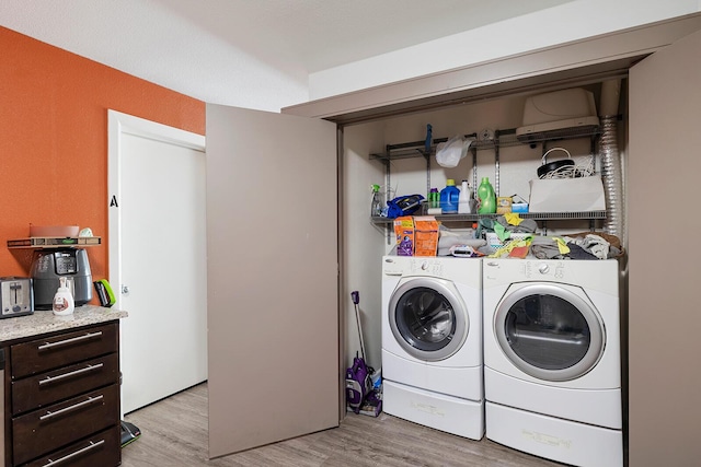 washroom featuring washing machine and dryer and light wood-type flooring