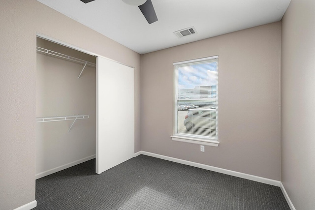 unfurnished bedroom with carpet floors, a closet, and ceiling fan