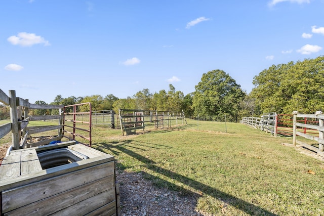 view of yard with an outbuilding and a rural view