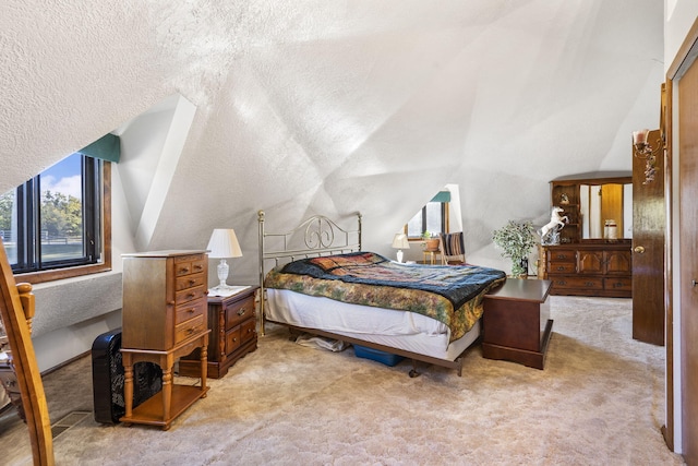 carpeted bedroom featuring a textured ceiling and lofted ceiling