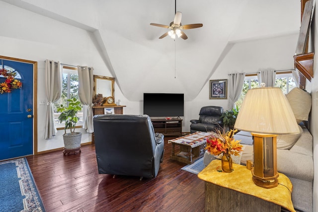 living room with ceiling fan, a healthy amount of sunlight, dark hardwood / wood-style flooring, and vaulted ceiling