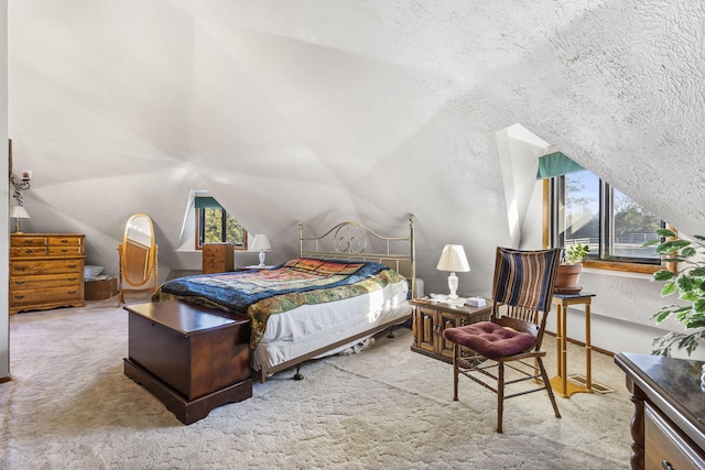 bedroom featuring a textured ceiling, multiple windows, and lofted ceiling